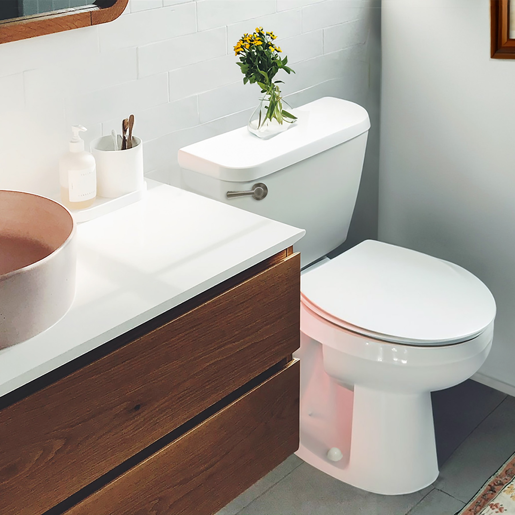 Brushed nickel toilet handle shown in a bathroom