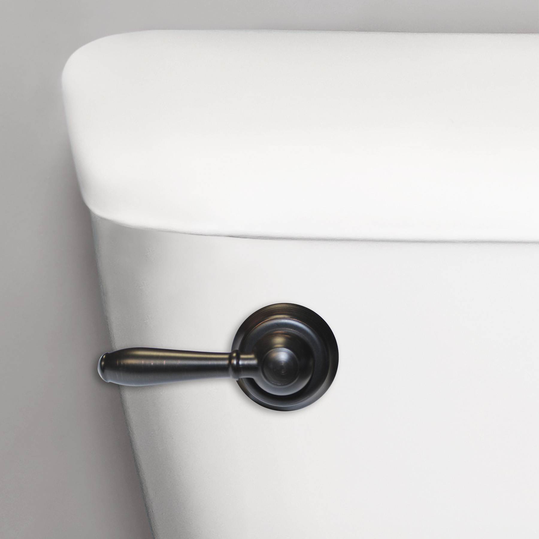 Close up image of oil rubbed bronze toilet handle on a toilet
