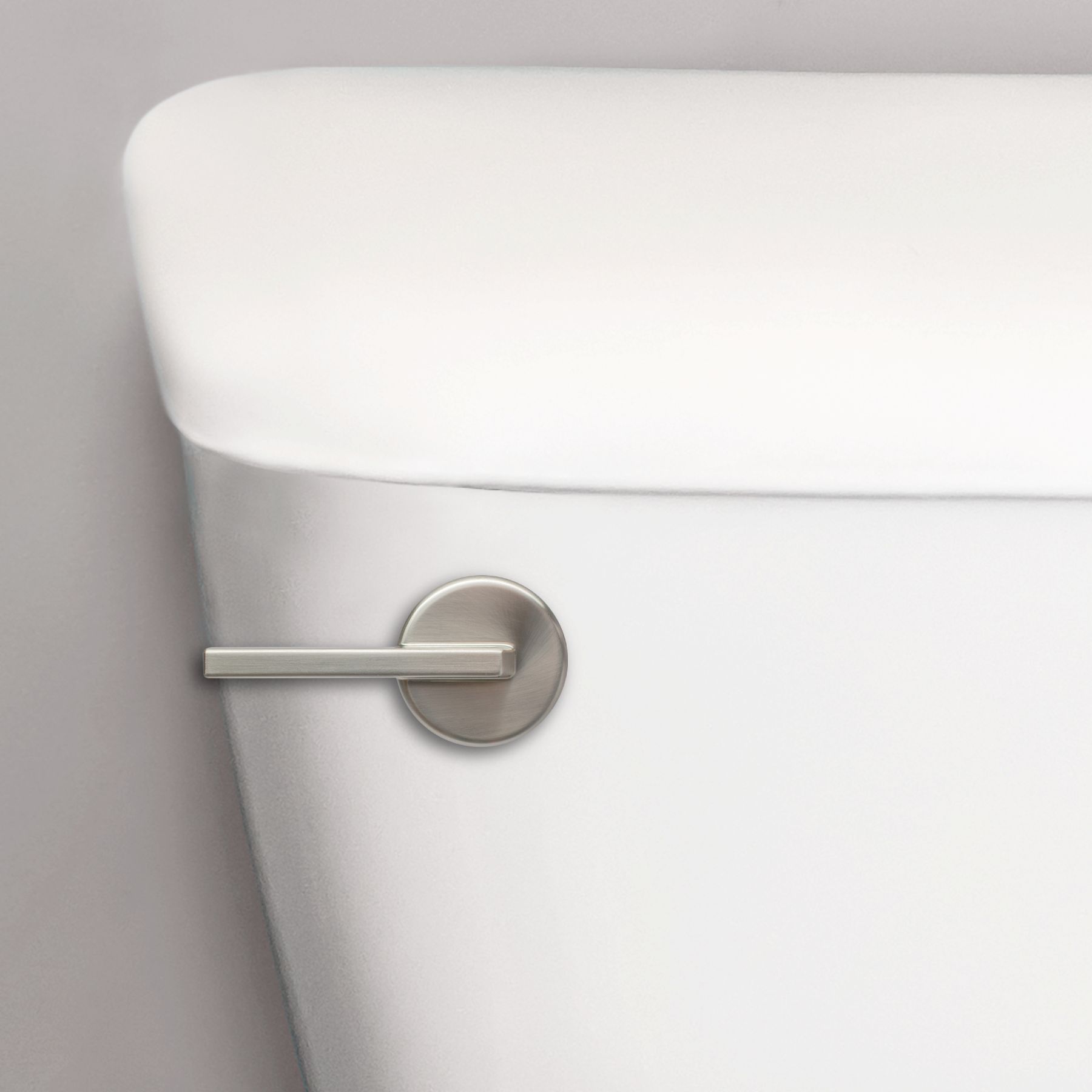 brushed nickel contemporary toilet handle on a toilet tank